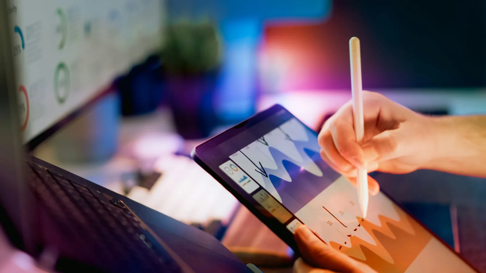 Hand reviewing marketing analytics on a tablet