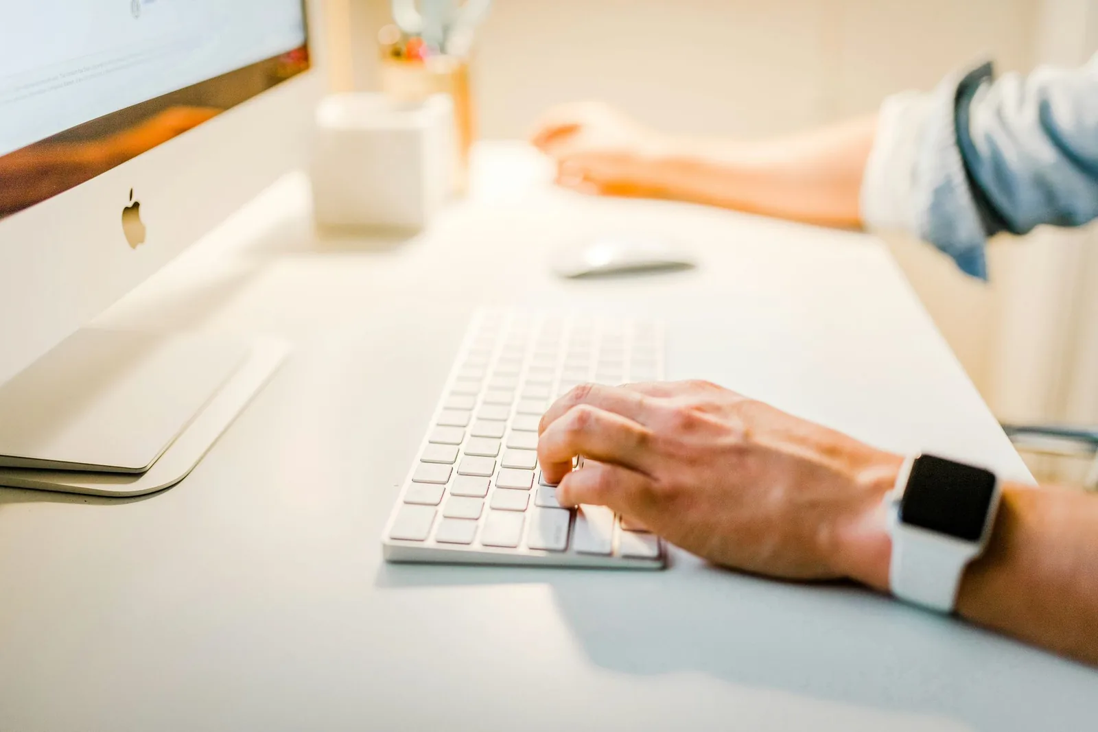 Hand typing on a keyboard, researching profitable affiliate products